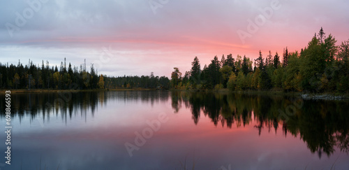 Red evening clouds over a small wilderness lake in Northern Finland