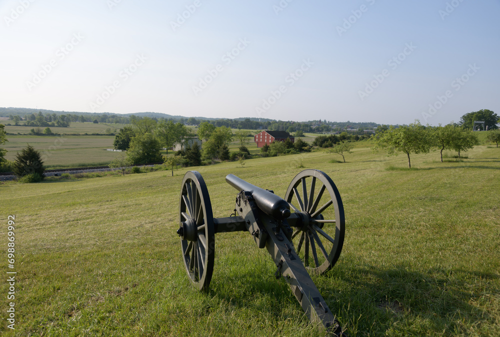 10 pounder Parrott riffled cast iron artillery piece model 1861 at Gettysburg. Battlefield in the background
