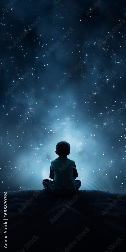 A boy appears from behind and sits looking at the stars A boy appears from behind and sits looking at the stars