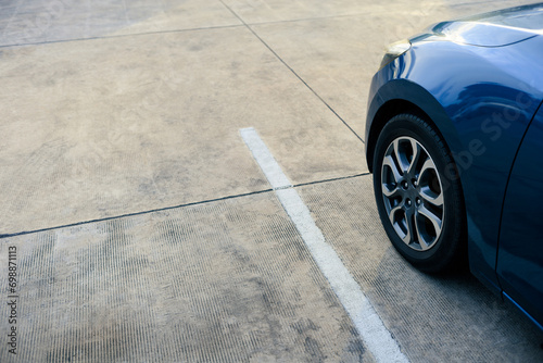 close up of modern car in parking lot, grunge surface of street, car parked in the right position in outdoor shopping plaza carpark area, shallow depth of field photo