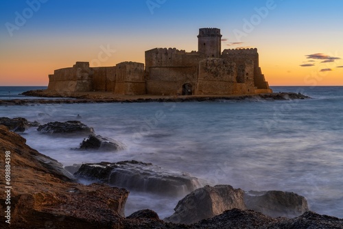 view of the Le Castella fortress in Isola di Capo Rizzuto at sunset