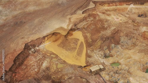 Gold mining. Flushing the rock with an old dredge. View from above. Environmental pollution