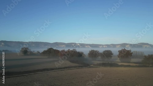 Extensive cultivated fields seen from the air, covered in fog in the surroundings of Taradell, Vic, Barcelona photo