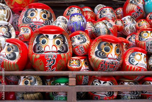 Traditional Japanese daruma dolls piled up at Shorinzan Daruma-ji Temple in Gunma Prefecture in Japan photo