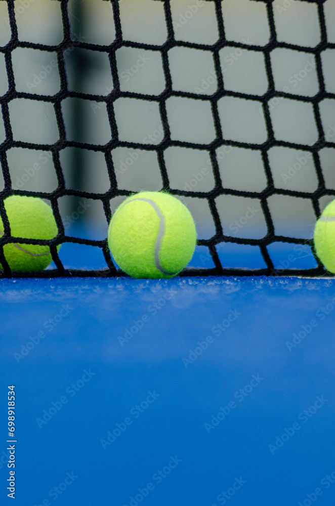 three balls on a paddle tennis court, selective focus