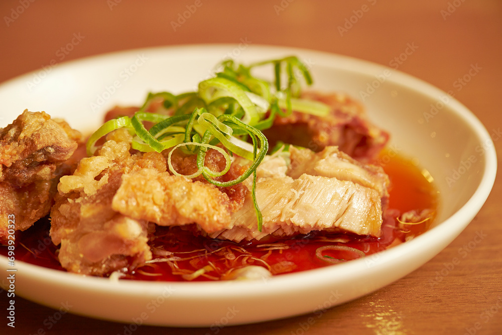 Fried chicken with green onion on a plate Fried chicken with green onion on a plate