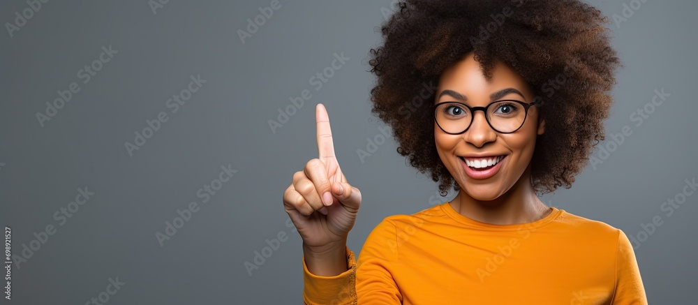 African American woman with an empty frame, pointing finger with a happy face, number one. - obrazy, fototapety, plakaty 