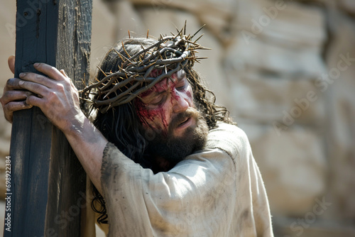 Jesus Christ wearing a crown of thorns carries his cross, Good Friday