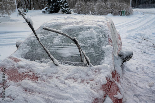 Frozen windscreen and snow on car a cold winterday photo