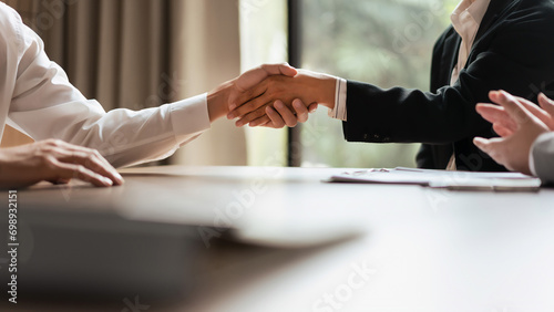 HR manager woman shaking hand and congratulation with male candidate after successful interviewing photo