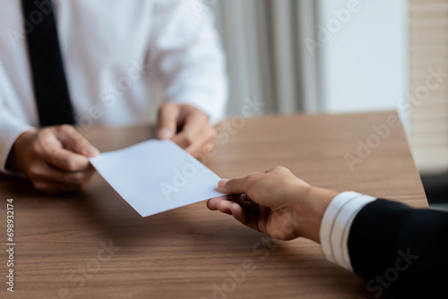 Executive sending resignation letter to male employee for cancel contract and layoff job photo