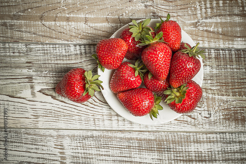 Red strawberries on wooden background