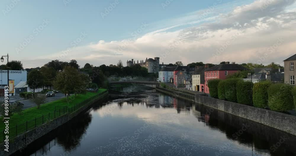 Flying over the river Nore in the ancient city of Kilkenny with Kilkenny Castle on background