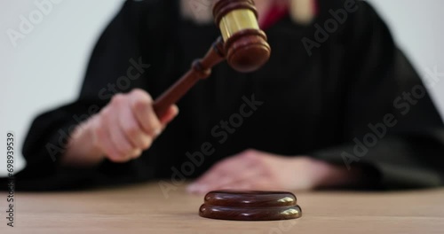 Judge knocking with wooden gavel in courtroom 4k movie slow motion photo