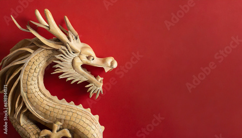 Wooden Dragon on red background. with copy space in the top left corner for an invitation, booklet, banner