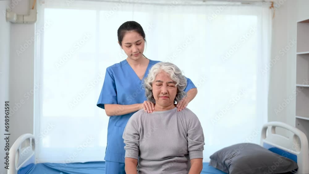 Asian physiotherapist helping elderly woman patient stretching arm in hand during training hand with patient Back problems in bed