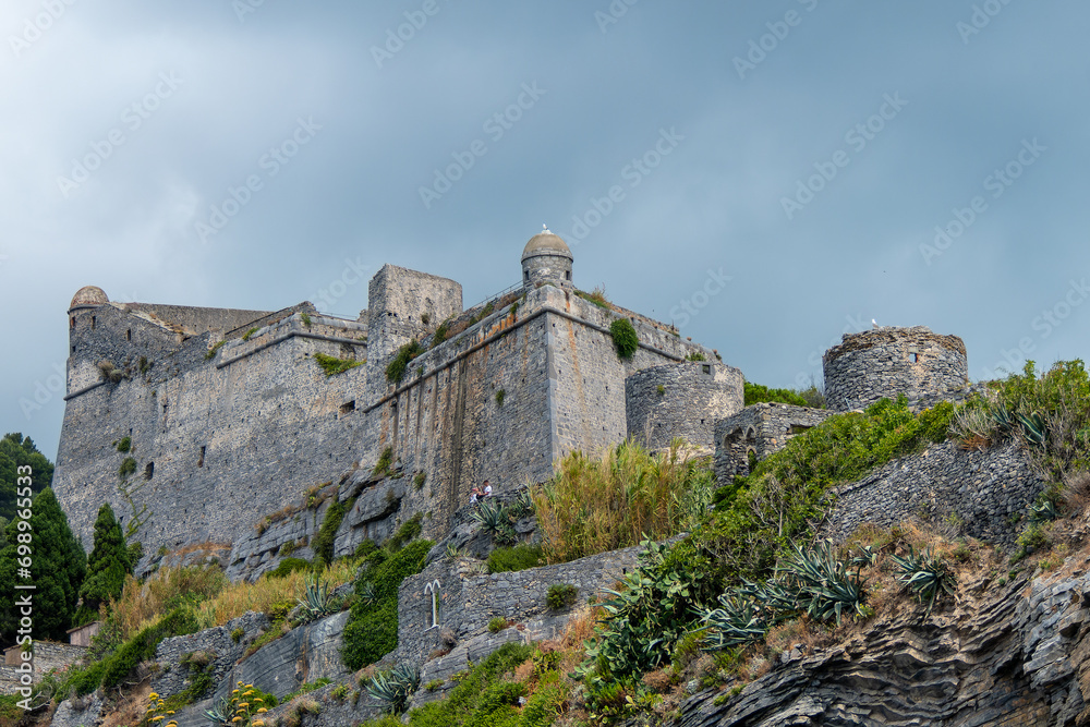 Portovenere, Italy, July 30, 2023. Doria Castle, military fortress, on the heights of the sea and the village
