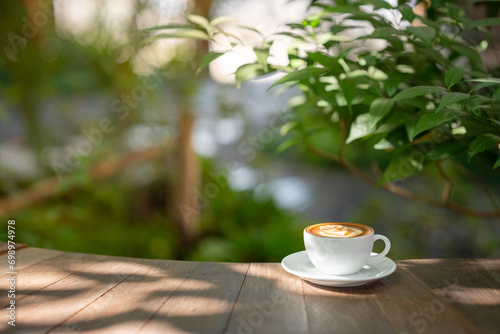 Hot art Latte Coffee. Background Coffee cup and beans on old kitchen table. 