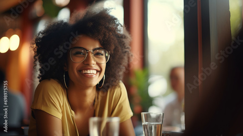 Black afro American business woman having a friendly lunch with colleagues at a local cafe, she engages in casual conversation, fostering a positive and collaborative atmosphere photo