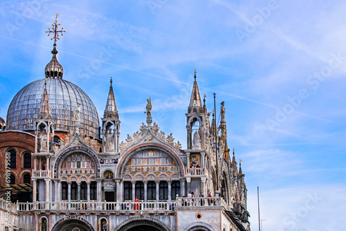 part of St. Mark's Basilica in the evening with tourists against the blue sky in Venice in September 2023 photo