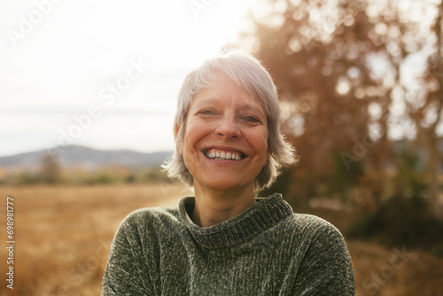 Happy woman with gray hair at field photo
