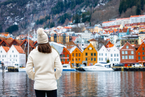 Konstfotografi A tourist woman looks at the colorful Bryggen district in Bergen, Norway, during