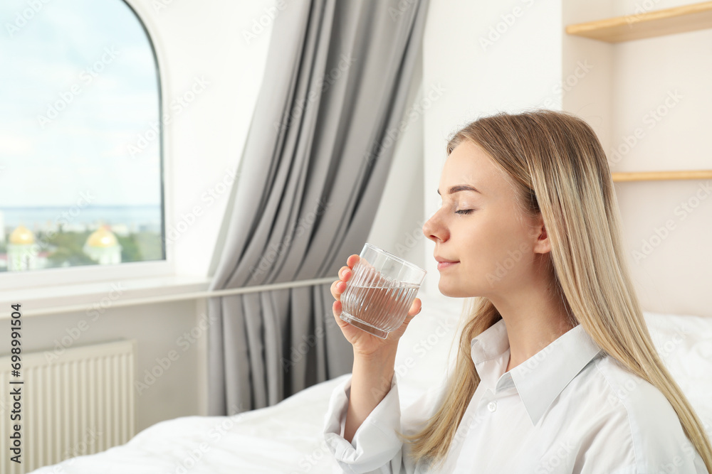 Young woman drinking water from a cup close-up Young woman drinking water from a cup close-up