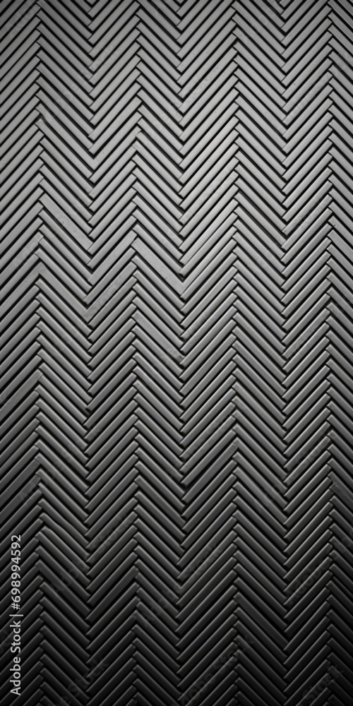 A sleek slate grey metal surface with a central sheen, framed by a unique zigzag pattern.Generative AI.