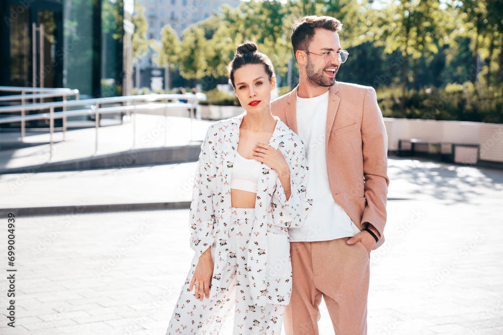Beautiful fashion woman and her handsome elegant boyfriend in beige suit. Sexy brunette model in summer clothes. Fashionable smiling couple posing in street Europe. Brutal man and female outdoors Beautiful fashion woman and her handsome elegant boyfriend in beige suit. Sexy brunette model in summer clothes. Fashionable smiling couple posing in street Europe. Brutal man and female outdoors