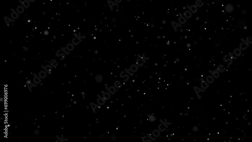 White snow bokeh falling overlay on black background. abstract dust particles snowflakes and snowfall slowly falling motion effect for christmas holiday festival. Luxury decorative element. photo
