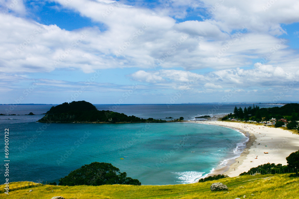 Maunganui beach and Moturiki Island , Tauranga, New Zealand. Beautiful landscape of a bay with sandy white beach and turquoise sea. Travel destination
