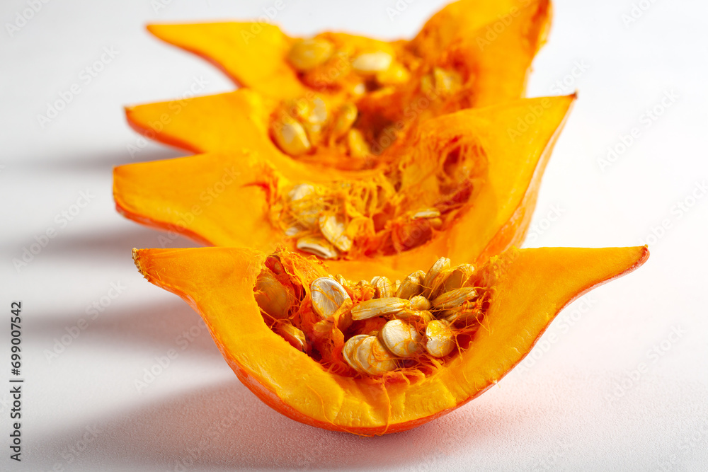 Pumpkin pieces on a white background. The concept of healthy eating Pumpkin pieces on a white background. The concept of healthy eating