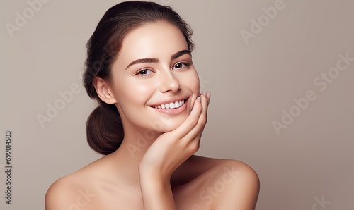 A woman smiling with her hands on her face