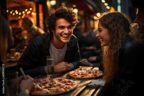 Happy young friends eating pizza in a restaurant