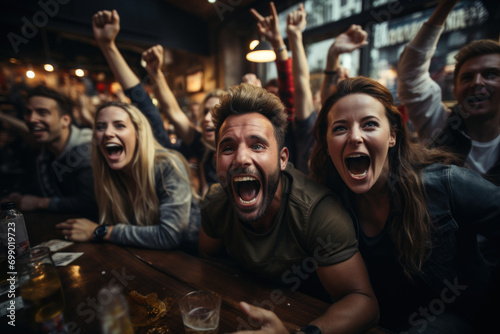 Group of young fans celebrate victory of favorite team watching match in pub