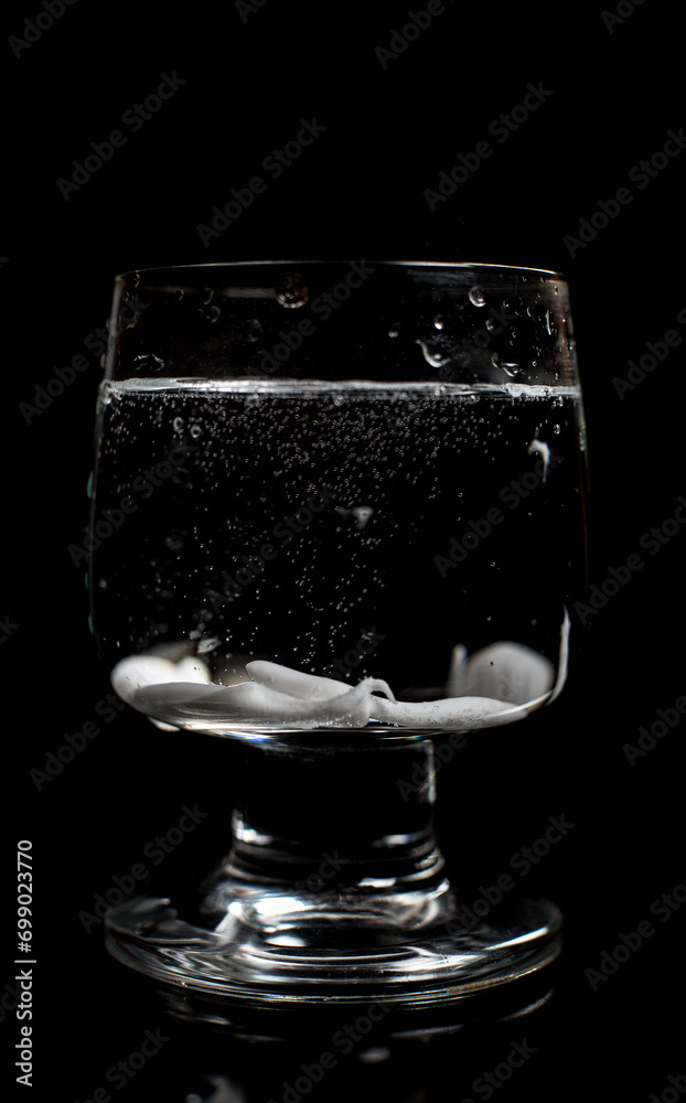 Clean water in a glass on a black background