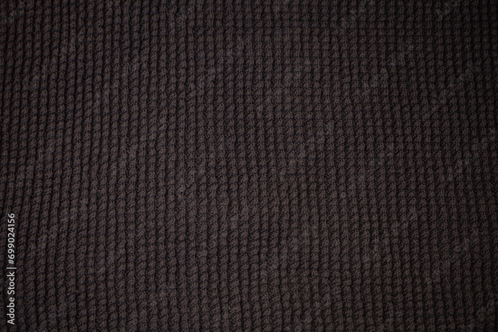 Dark fabric with waves and folds based on PVC.