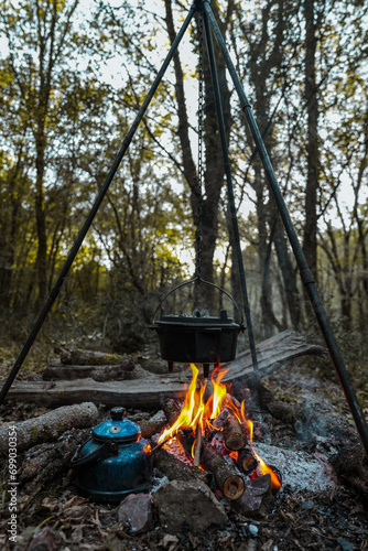 with knife, water bottle and titanium mug near the fire outdoors. bushcraft, adventure, travel, tconcept.ourism and camping