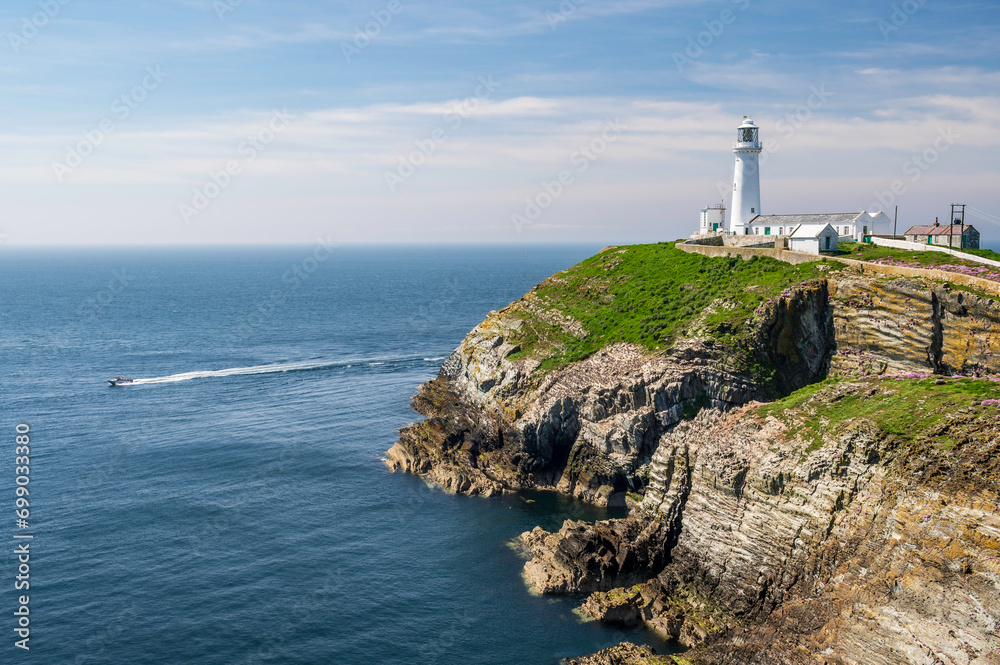 South Stack Lighthouse on the west coast of Anglesey in Wales, reached by a long, steep flight of stone steps.  The day is bright and sunny