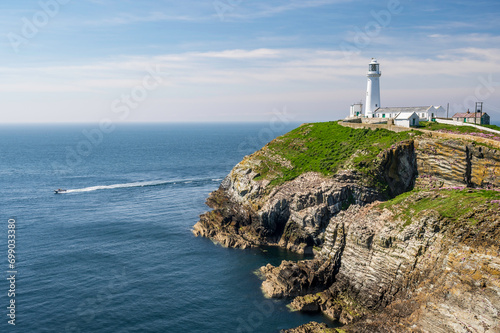 South Stack Lighthouse on the west coast of Anglesey in Wales  reached by a long  steep flight of stone steps.  The day is bright and sunny