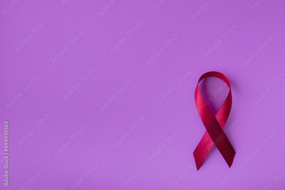 Pink ribbon on a delicate background, top view with space for text. Campaign to help people facing cancer Pink ribbon on a delicate background, top view with space for text. Campaign to help people facing cancer