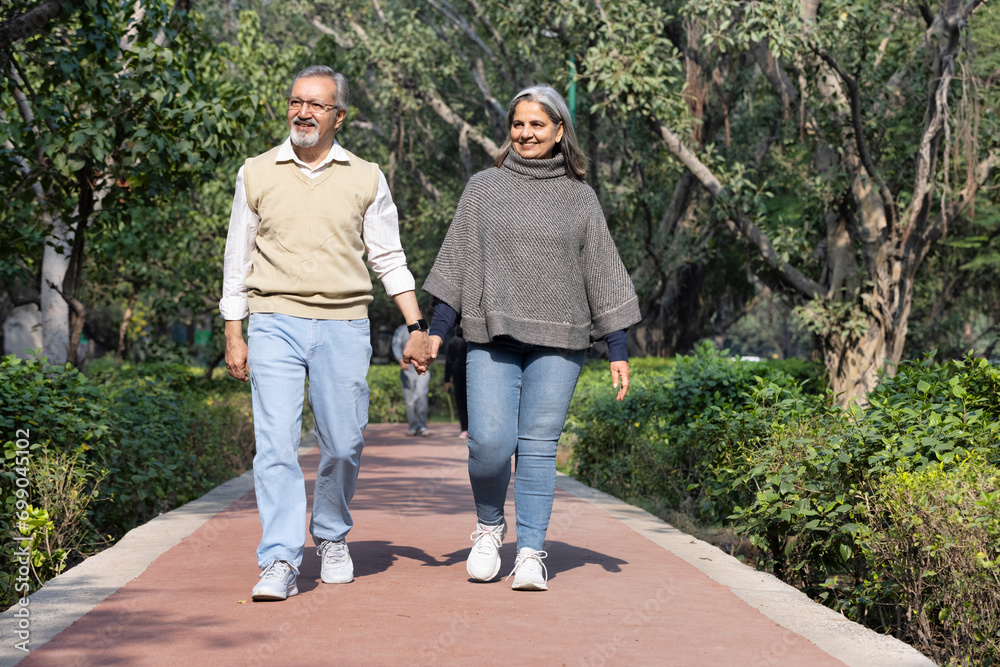 Smiling senior couple enjoying view of nature at public park Smiling senior couple enjoying view of nature at public park