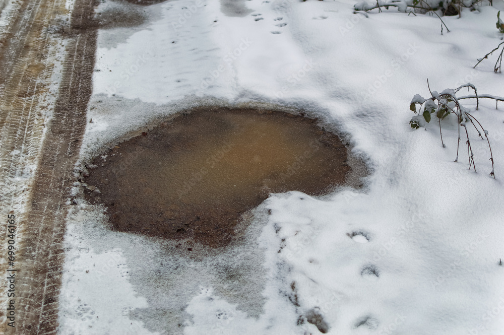 Frozen water at road during cold winter day.