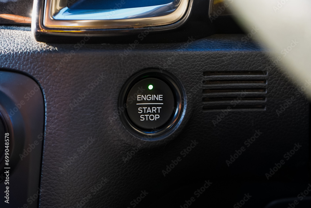 Obraz premium Close up engine car start button. Start stop engine modern new car button,Makes it easy to turn your auto mobile on and off. a key fob unique ,selective focus