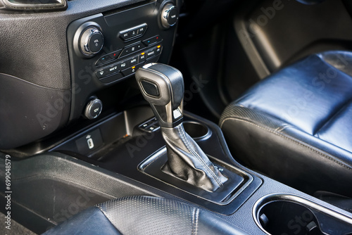 automatic transmission shift selector in the car interior. Closeup a manual shift of modern car gear shifter. 4x4 gear shift  © Muanpare