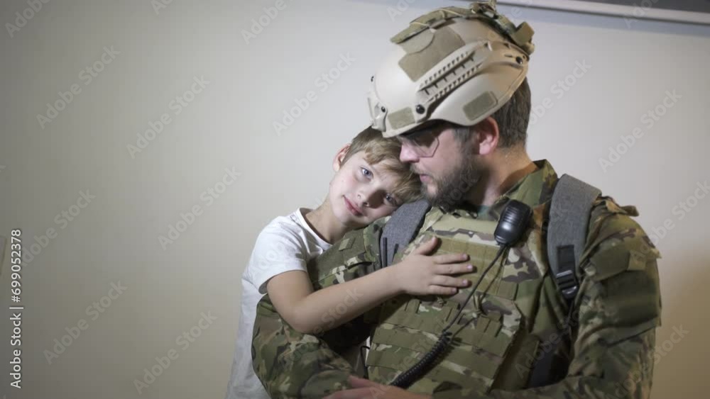 A soldier and his boy child son say goodbye
