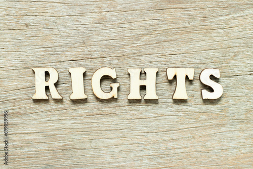 Alphabet letter in word rights on wood background photo