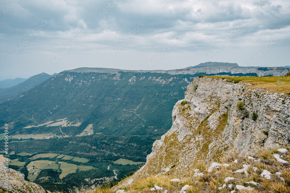 View of the alpine meadows of the Font d'Urle plateau in the Vercors (Drôme, France) with its cliffs, limestone rocks, and pastures View of the alpine meadows of the Font d'Urle plateau in the Vercors (Drôme, France) with its cliffs, limestone rocks, and pastures