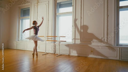 Ballerina dancing practicing near barre. Graceful professional classic ballet dancer woman training in ballet studio performing dance elements. Choreographer girl in pointe shoes, tutu. Sport workout. photo