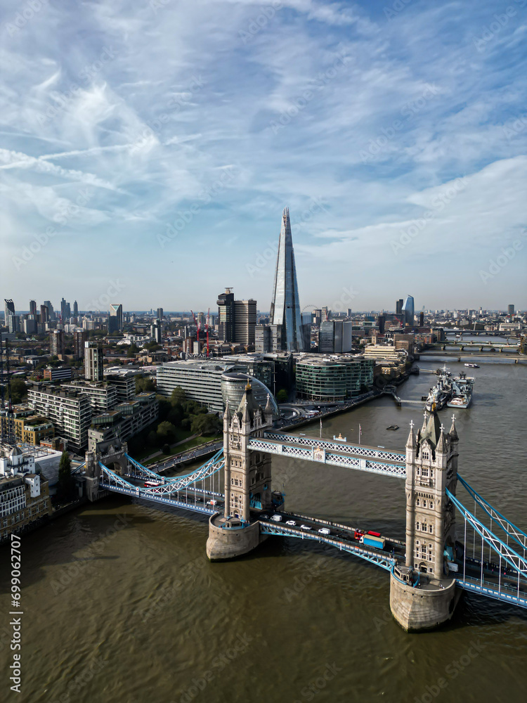 Iconic Tower Bridge Aerial drone View of Tower Bridge, Skyline. United Kingdom, UK.  Skyline of London business center the River Thames and passing above tower bridge.